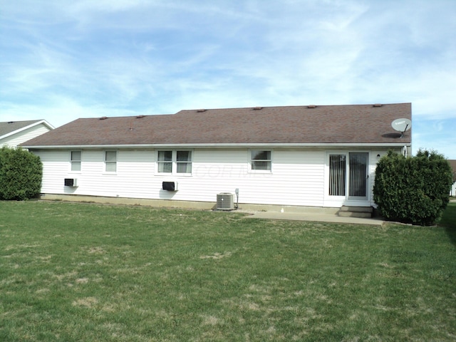 rear view of property with central air condition unit, a patio area, and a yard