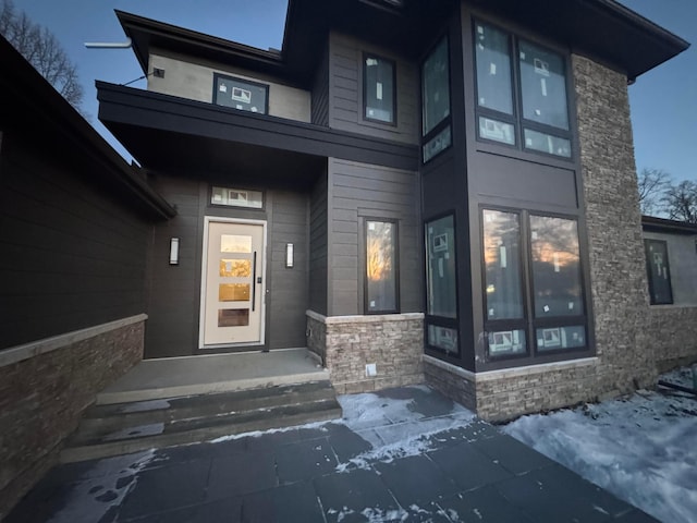 property entrance featuring stone siding