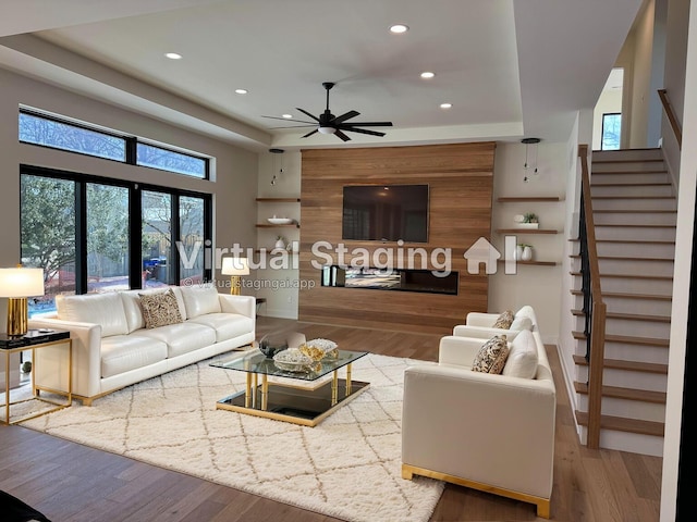 living room featuring a ceiling fan, stairway, wood finished floors, and recessed lighting