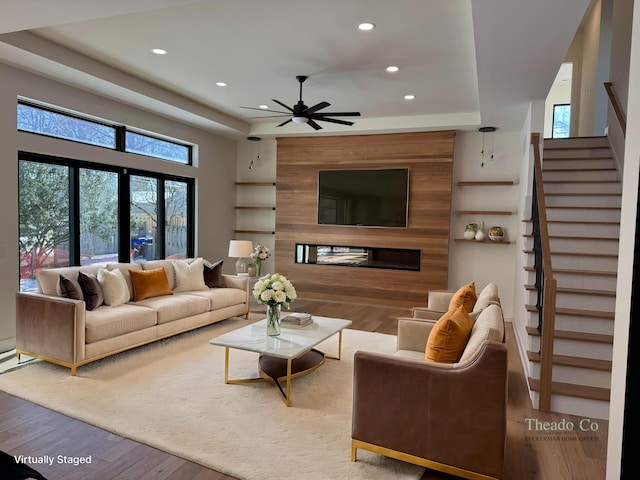 living area with stairs, recessed lighting, a ceiling fan, and wood finished floors