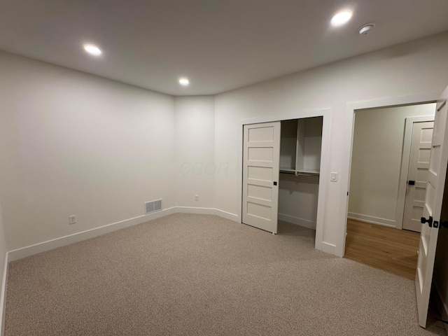 unfurnished bedroom featuring visible vents, baseboards, carpet flooring, and recessed lighting