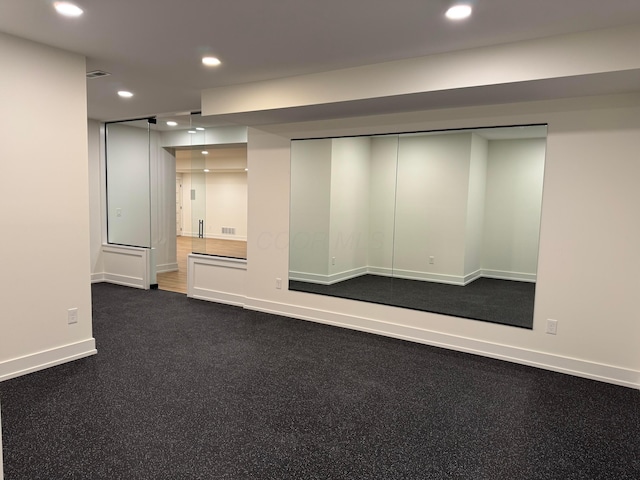 spare room with recessed lighting, visible vents, and baseboards