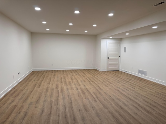 empty room with visible vents, wood finished floors, and recessed lighting