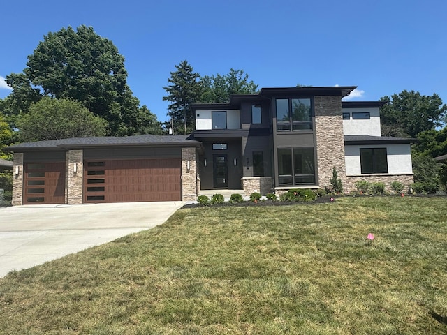 3130 S Dorchester Rd, Columbus, OH 43221 - contemporary house with stone siding, a garage, driveway, and a front yard