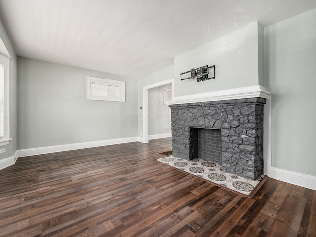 unfurnished living room featuring dark hardwood / wood-style floors and a fireplace