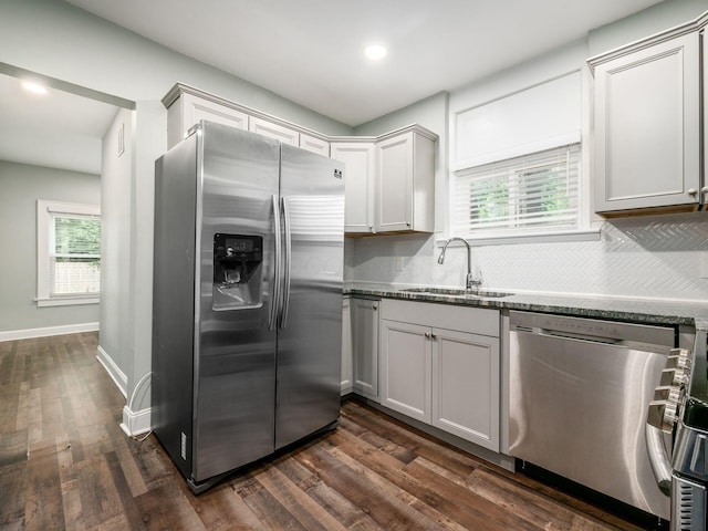 kitchen with a wealth of natural light, dark hardwood / wood-style flooring, sink, and appliances with stainless steel finishes