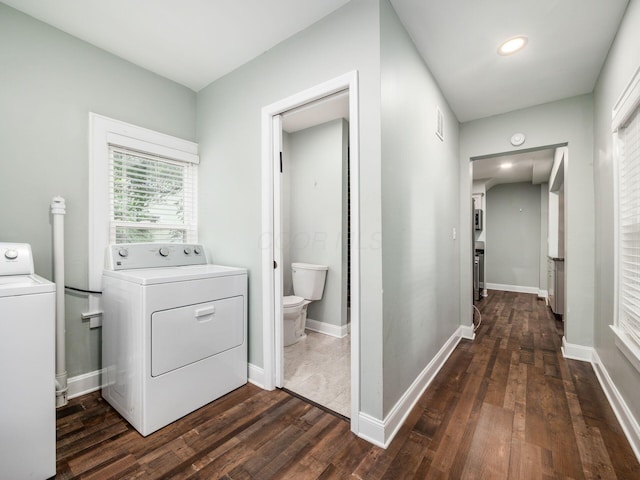 laundry area with independent washer and dryer and dark wood-type flooring