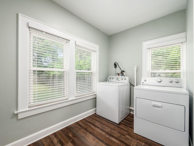 clothes washing area with a healthy amount of sunlight, dark hardwood / wood-style flooring, and separate washer and dryer