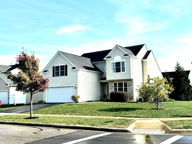 view of front property with a front lawn and a garage