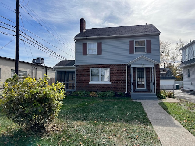 view of front of property with central AC unit and a front yard