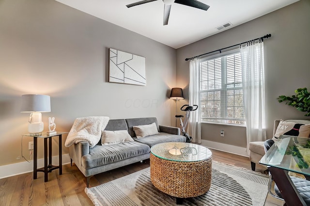 living room with hardwood / wood-style flooring and ceiling fan