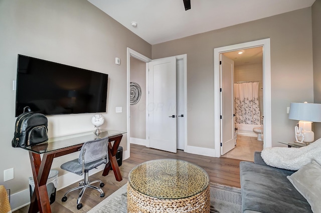 home office with wood-type flooring