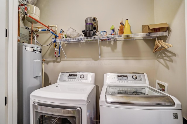 washroom with electric water heater and separate washer and dryer