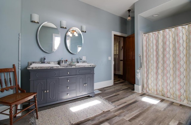 bathroom with hardwood / wood-style flooring, vanity, and a shower with curtain