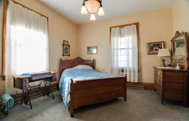 bedroom with light carpet and a chandelier