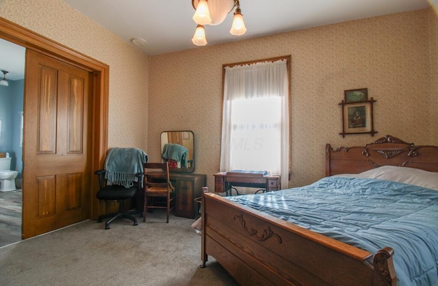 bedroom featuring carpet flooring and ensuite bathroom