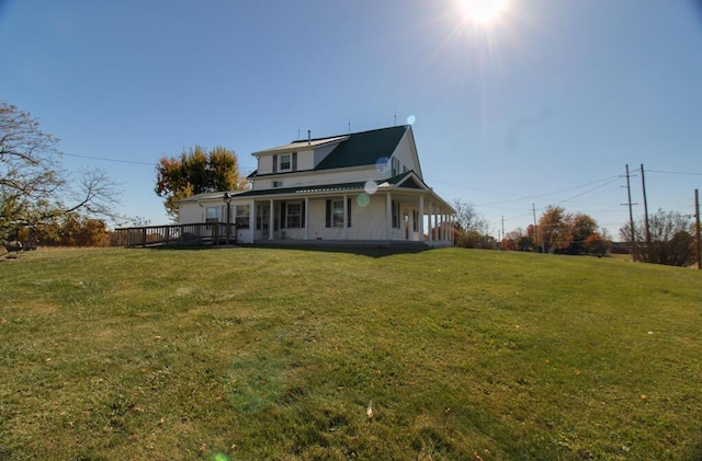 back of house featuring a yard and a deck