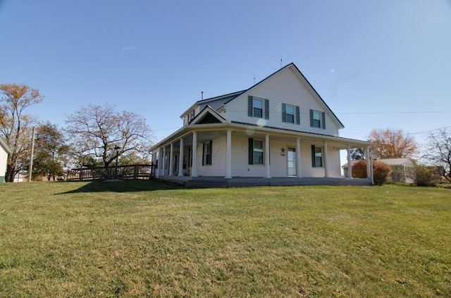 farmhouse inspired home featuring a front lawn and covered porch