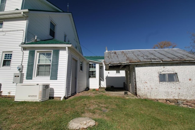 view of side of home with a lawn