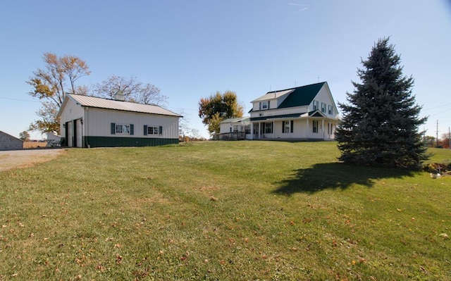 view of yard featuring a garage and an outdoor structure