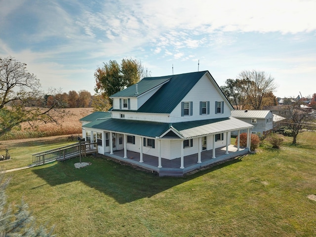 rear view of house featuring a lawn