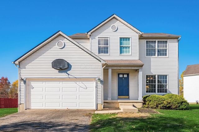 view of property with a front lawn and a garage