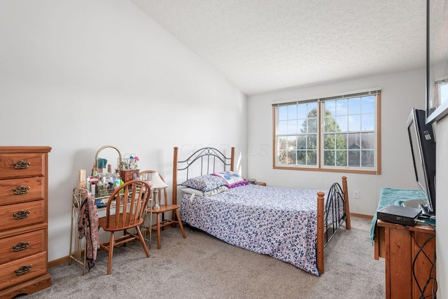 carpeted bedroom featuring a textured ceiling and vaulted ceiling