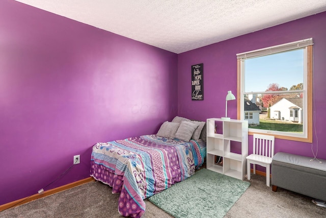 carpeted bedroom featuring a textured ceiling