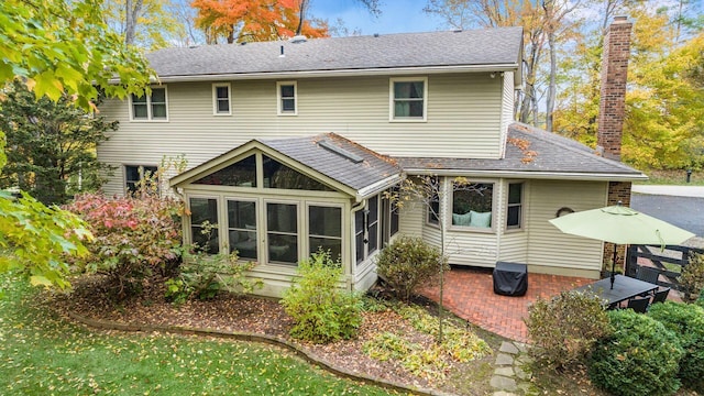 back of house featuring a sunroom