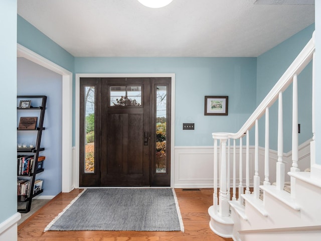 foyer entrance with hardwood / wood-style flooring