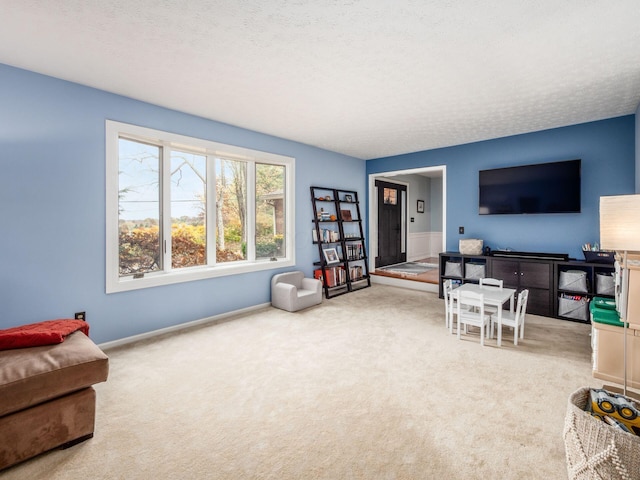 living room featuring carpet and a textured ceiling