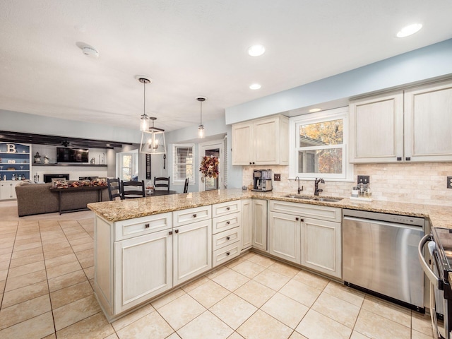 kitchen with kitchen peninsula, stainless steel appliances, light tile patterned flooring, and sink