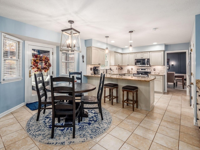 dining area featuring light tile patterned floors, a textured ceiling, and a chandelier