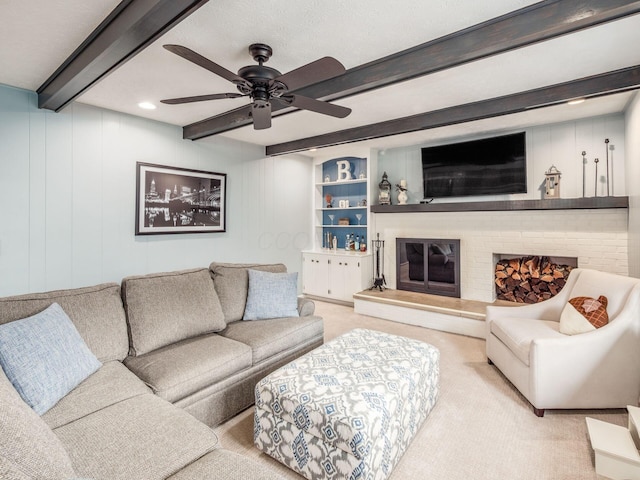 carpeted living room featuring ceiling fan and beamed ceiling