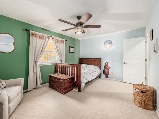 carpeted bedroom with a textured ceiling and ceiling fan