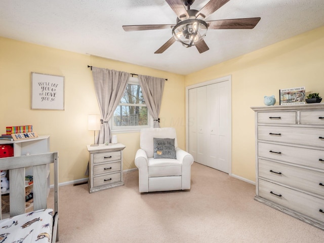 carpeted bedroom with a textured ceiling, a closet, and ceiling fan