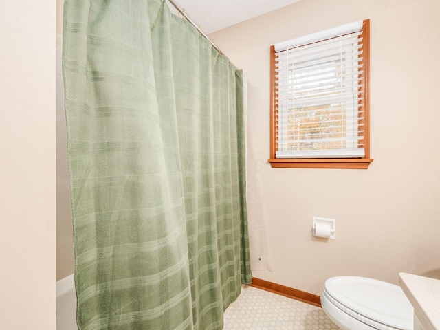 bathroom with toilet and walk in shower