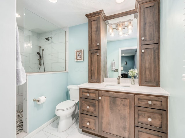 bathroom with vanity, toilet, and tiled shower