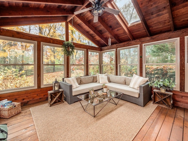 sunroom / solarium with a wealth of natural light, ceiling fan, wood ceiling, and lofted ceiling with skylight