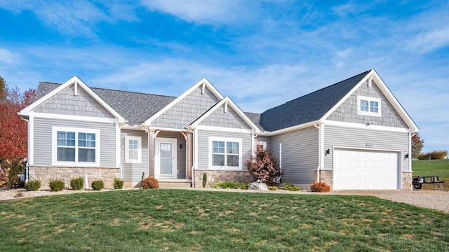 craftsman-style home featuring a front yard and a garage