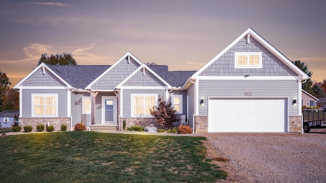 craftsman house with a lawn and a garage