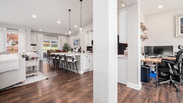 office space with dark wood-type flooring and vaulted ceiling