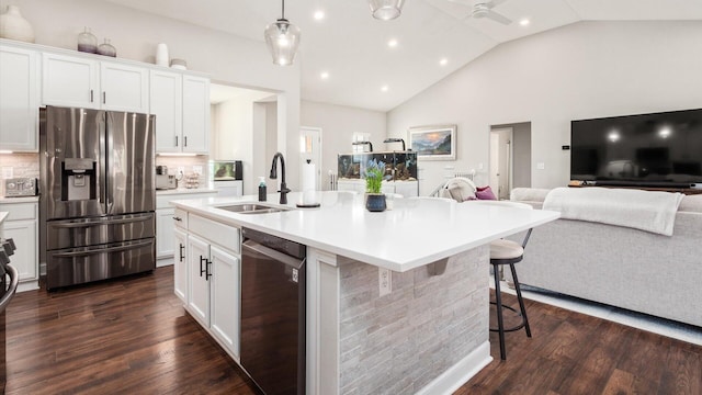 kitchen with appliances with stainless steel finishes, white cabinetry, and dark wood-type flooring