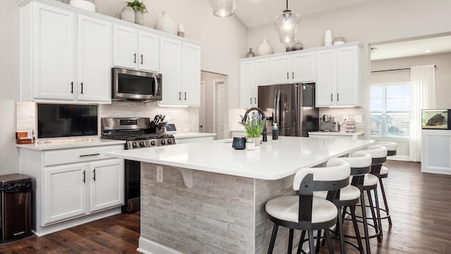 kitchen featuring a kitchen island with sink, white cabinetry, sink, and appliances with stainless steel finishes