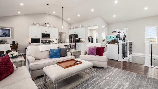 living room with high vaulted ceiling, dark wood-type flooring, and sink