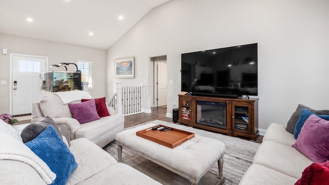 living room featuring hardwood / wood-style flooring and high vaulted ceiling