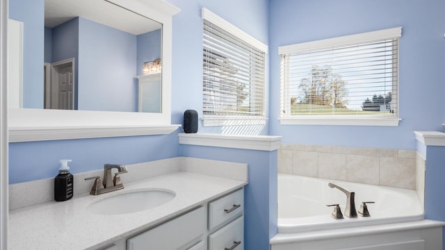 bathroom featuring vanity and a tub