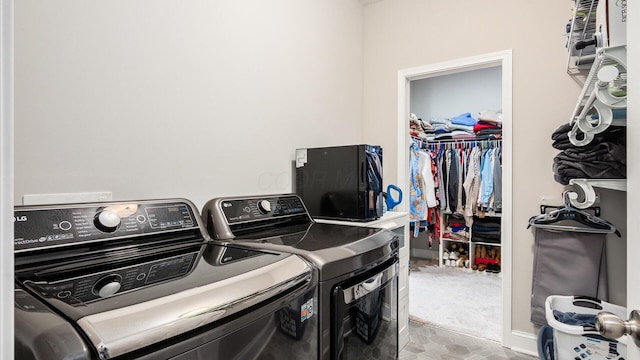 clothes washing area with washer and clothes dryer