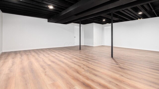 basement with light hardwood / wood-style floors