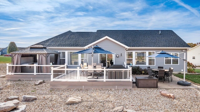 rear view of property with a wooden deck